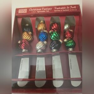 This is a Basics Christmas Fantasy 4-piece stainless steel spreader set.